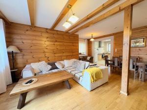 a living room with a couch and a table at Dębowa Dziupla in Białowieża