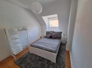 a small bedroom with a bed and a window at Süße Marie 6 in Karlsruhe