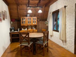 a dining room with a wooden table and chairs at Welpen Chapa in Mar del Plata