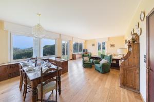 a large living room with a table and a dining room at Villa Elisa by Whale Homes in Padenghe sul Garda