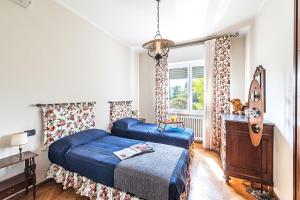 a bedroom with two beds and a guitar at Villa Elisa by Whale Homes in Padenghe sul Garda +34 photos
