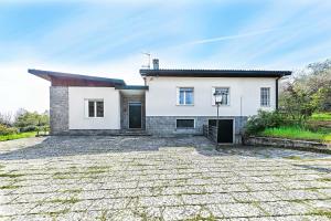 a house with a stone driveway in front of it at Villa Elisa by Whale Homes in Padenghe sul Garda