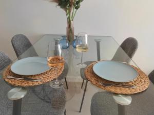 a glass table with two wine glasses and a vase at La Mosa Sol in San Javier +27 photos
