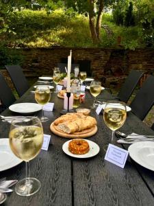 a table with glasses of wine and food on it at Hofgut Eveshausen - Dreiseitenhof - Spielscheune - Landidylle - Hofleben in Dommershausen