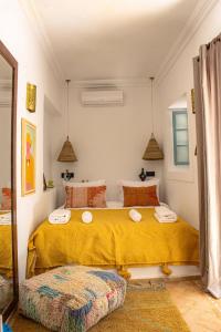 a bedroom with a large bed with yellow sheets at Riad Dar Ben Slimane in Marrakech