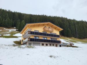 a building with solar panels on it in the snow at Gästehaus Bischof in Damuls +31 photos