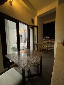a table in a room with a view of a bedroom at Tulip Elegant Riverside Hotel in Vang Vieng
