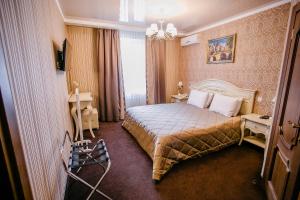 a bedroom with a bed and a dresser at Aristokrat in Vinnytsya