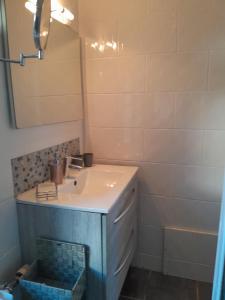 a bathroom with a sink and a mirror at Les oyats in Le Crotoy +6 photos