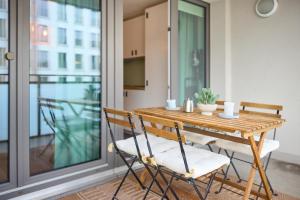 a wooden table and chairs on a balcony at Großzügiges Studio-Apartment in Dresden