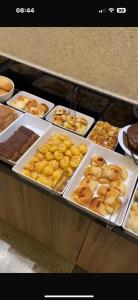 a display of donuts and other pastries in a bakery at Cristal Park Hotel in Cristalina