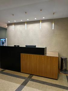 a reception desk in an office with pendant lights at Cristal Park Hotel in Cristalina +23 photos