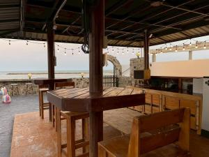 a restaurant with a table and chairs and a view of the ocean at บ้านดาริน บีช Baan Darlin Beach in Phetchaburi