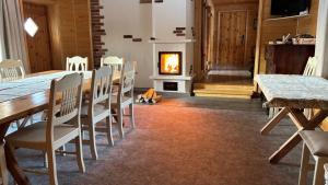 a dining room with a table and a fireplace at Männi Farm Holiday House in Eoste