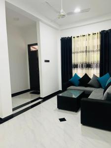 a living room with a couch and a window at moonlight villa in Weligama