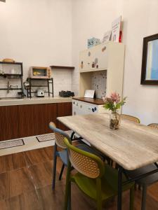 a kitchen with a wooden table and chairs at Villa Dino Park Batu in Karangploso