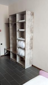 a room with a book shelf with towels at Berloga Hotel in Pavlodar
