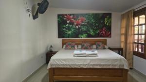 莱蒂西亚Kanaq Hotel Tours的卧室里有一张床，床上放着两条毛巾。