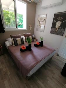 a bedroom with a large bed with plants on it at Lodge Eden Caraibes 6p avec piscine privée 6x3 in Sainte-Anne