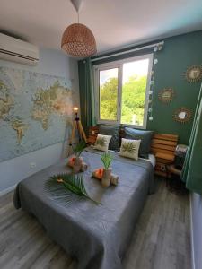 a bedroom with a large bed with flowers on it at Lodge Eden Caraibes 6p avec piscine privée 6x3 in Sainte-Anne