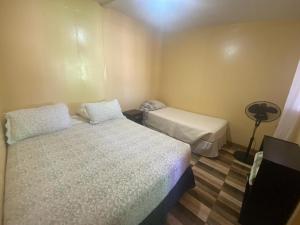 a small room with two beds and a lamp at Estrella Ancestral 1 in San Pedro de Atacama