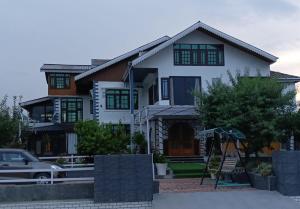 a house with a car parked in front of it at Id villa cottage in Tangmarg