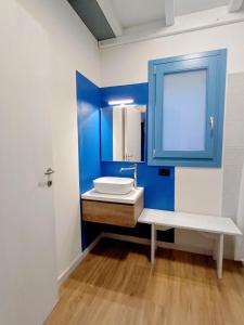 a bathroom with a sink and a blue cabinet at Jazz House in Solanas