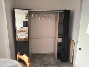 a closet with a refrigerator in a room at Charmant studio in Le Tholy