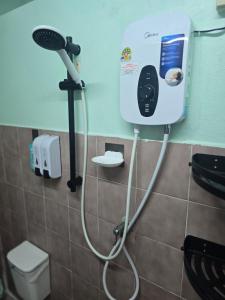 a bathroom with a hair dryer on the wall at 103 Lovely AC apartment with private kitchen in Bangkok