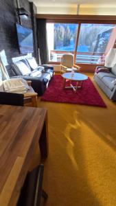 a living room with a couch and a coffee table at 4 Valleys Ski In in Nendaz