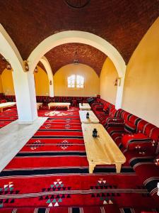 a room with long tables and red leather chairs at Happy Oasis Hotel in Siwa +61 photos