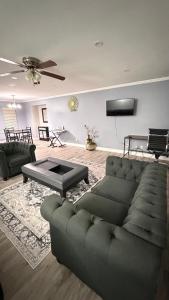 a living room with a couch and a table at J & J Dream Villa Ltd in Abbotsford