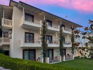 an apartment building with balconies and plants at Valentinos House in Parga