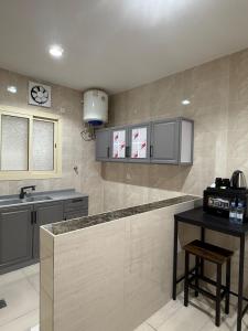 a kitchen with a counter and a sink and a counter top at استديو كلاود غرفتين نوم in Al Baha