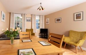 a living room with a table and chairs at Ashe Street in Clonakilty