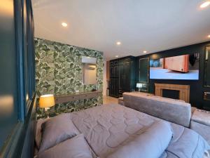 a bedroom with a large bed and a fireplace at Rarin jinda RESIDENCE in Suratthani