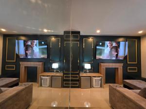 a living room with two sinks and a tv at Rarin jinda RESIDENCE in Suratthani +12 photos