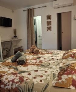 a bedroom with a bed with a floral bedspread at A Casa Faggia in Sollacaro