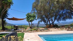 a villa with a swimming pool and a view at A Casa Faggia in Sollacaro +7 photos
