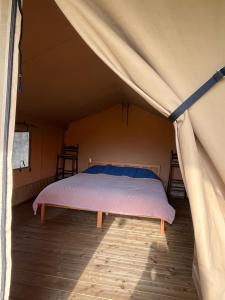 En eller flere senge i et værelse på Erve Zonnehoeve Minicamping en Wijngaard