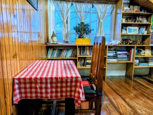 a table with a red and white checkered table cloth at Foggy Hill's Darjeeling in Darjeeling