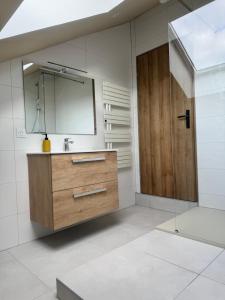 a bathroom with a sink and a mirror at Le gîte de L Échappée Alsacienne in Geispolsheim +29 photos