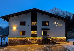 a building with a sign on the side of it at 1210 Apartments Benglerwald in Bach