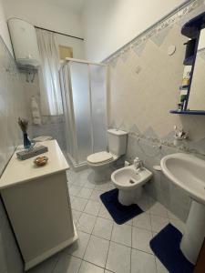 a bathroom with a toilet and a sink at Nuova Netum apartment in Noto
