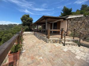 a house with a stone walkway outside of it at Terrazza Tramonto in Monte Argentario