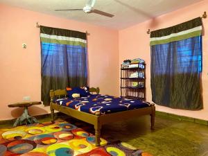 a bedroom with a bed and a rug at HIGSAM apartment in Diani Beach