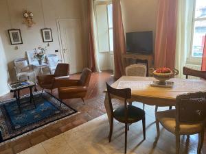 a living room with a table and chairs at Antica Casa Fenaroli in Iseo