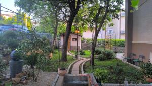 a garden with trees and plants in a building at Apartments Sabo in Kraljevica