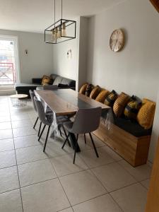 a living room with a table and a couch at Residentie Sofie in Koksijde