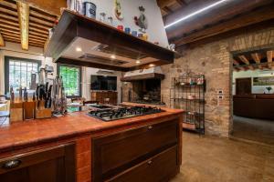 a kitchen with a stove and a counter top at Il Salice Country Luxury in Due Carrare